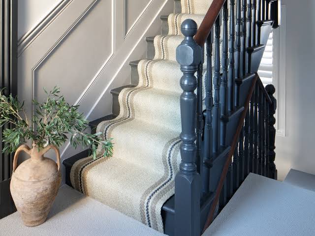 Stair runner carpet installed on a wooden staircase in a Dubai home